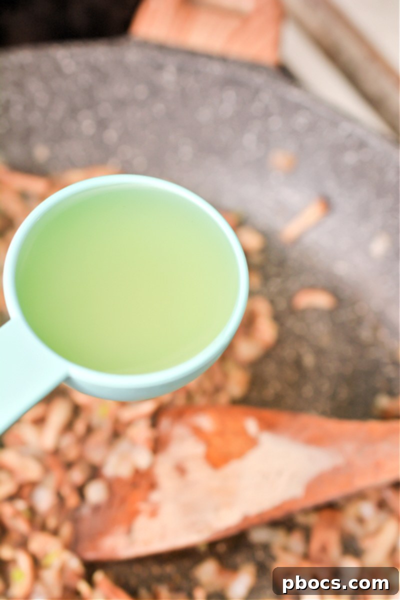Whisking in broth, cream, and parmesan cheese
