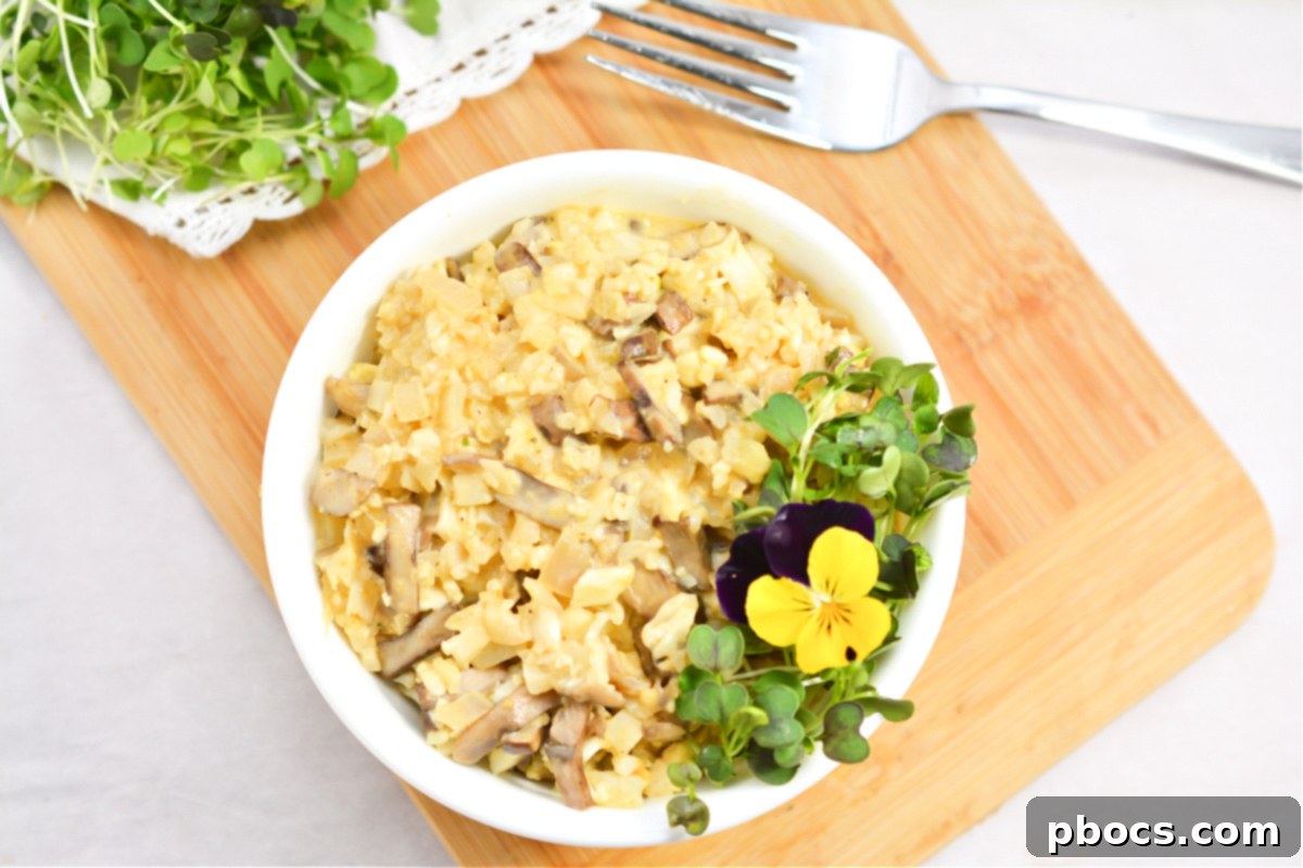 Closeup of Keto Mushroom and Pumpkin Risotto with edible pansy garnish
