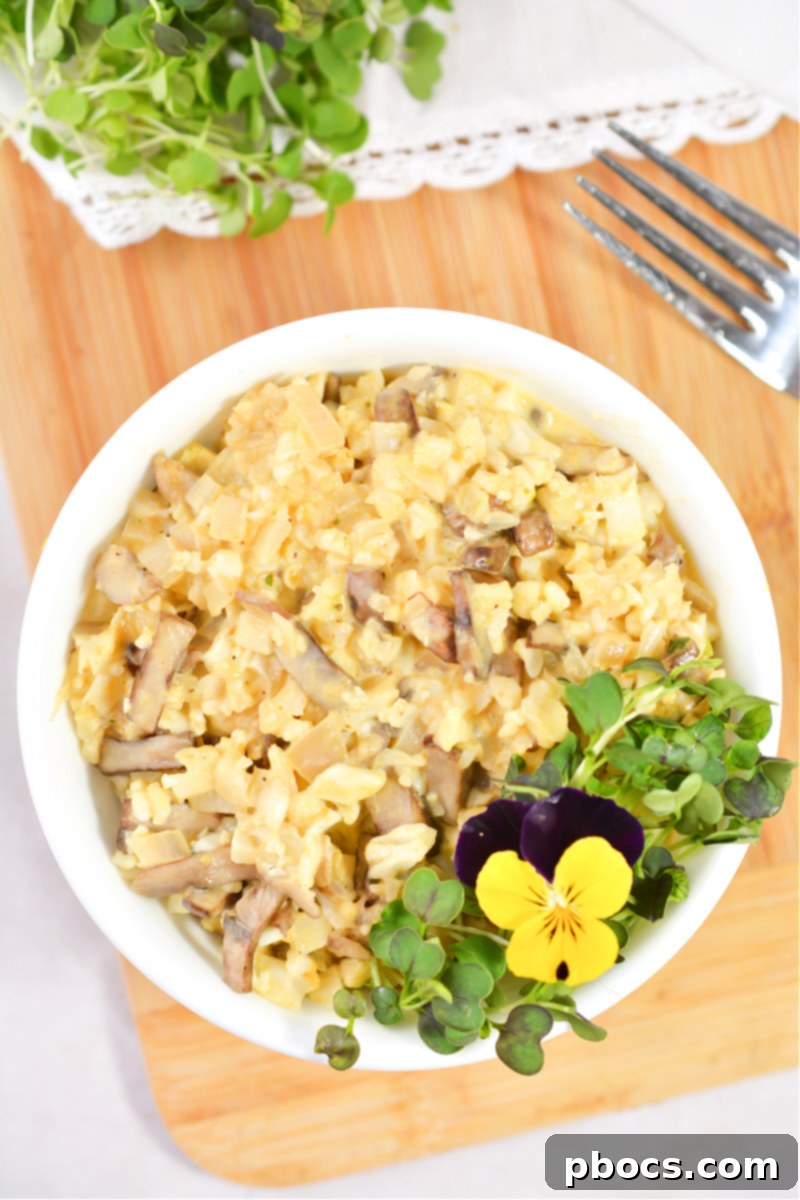 Serving of Keto Mushroom and Pumpkin Risotto with edible pansies