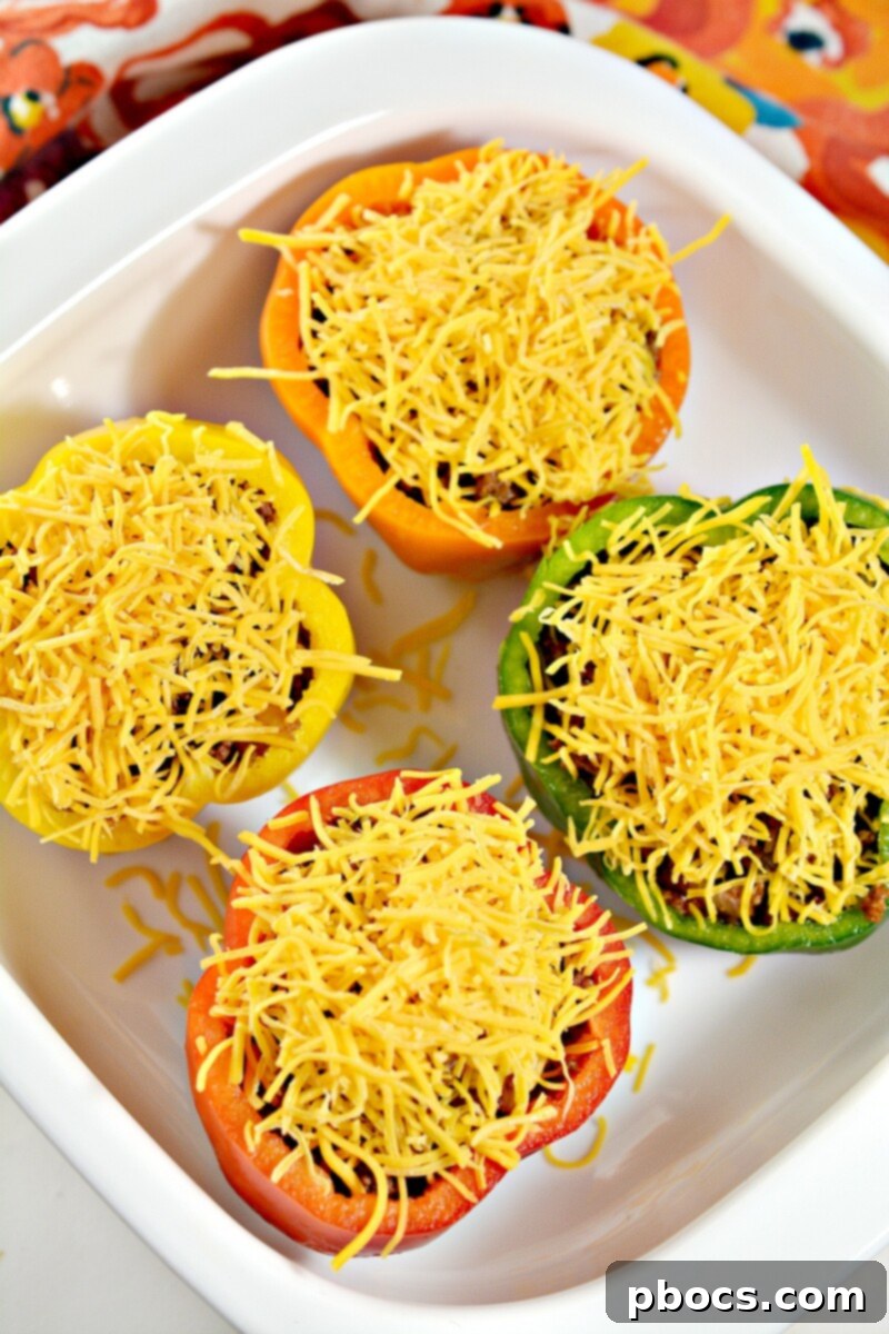 Keto Sloppy Joe Bell Pepper Boats 14 Baking dish with foil tented over cheese-topped stuffed peppers