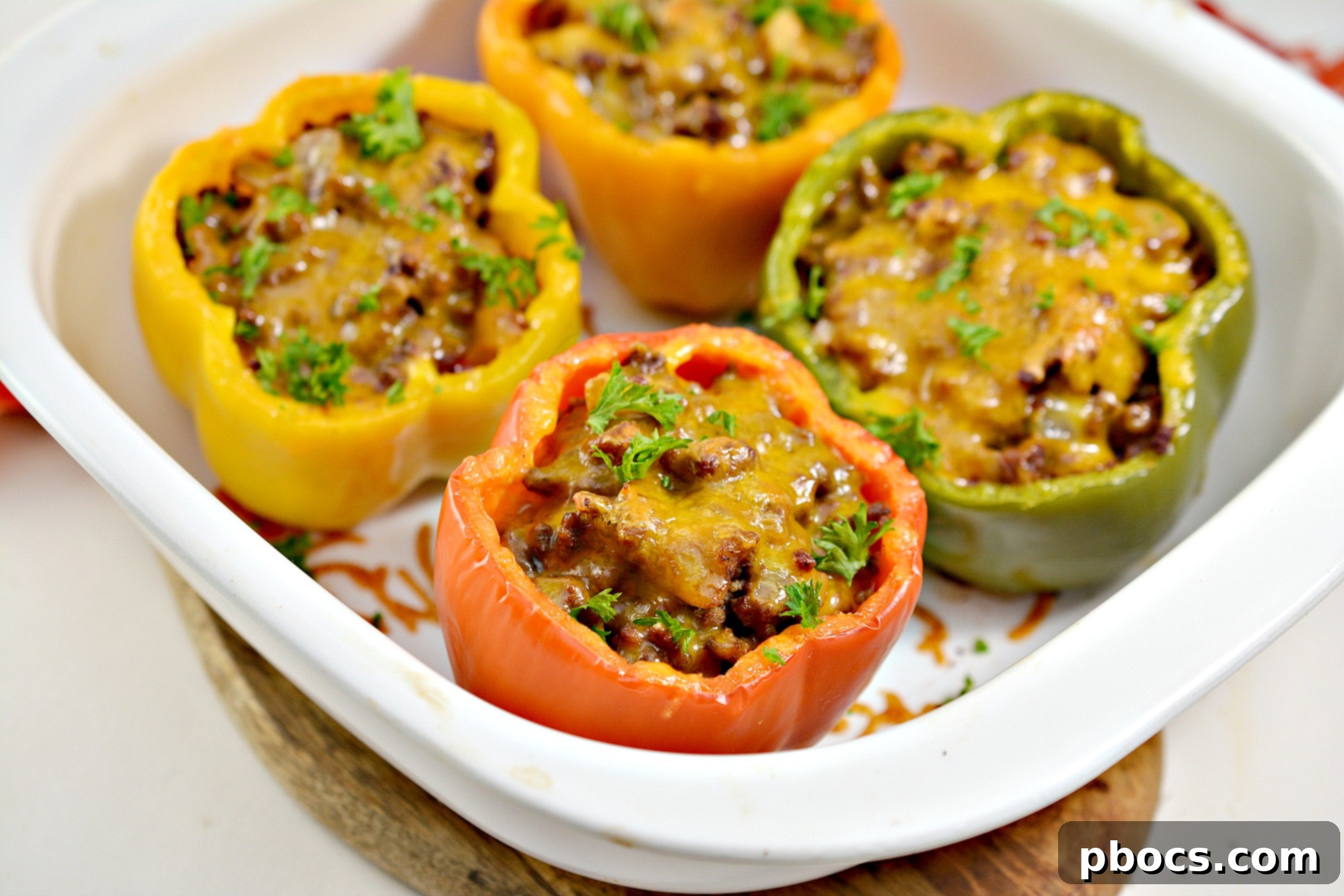 Keto Sloppy Joe Bell Pepper Boats 5 Various Keto Sloppy Joe Stuffed Peppers cooking in a baking dish
