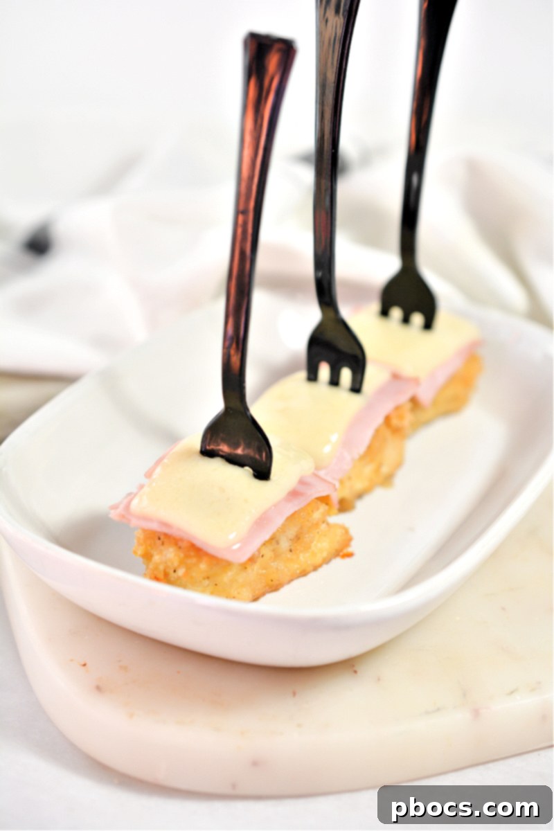 Keto Cordon Bleu Chicken Poppers 2 Crispy Keto Chicken Cordon Bleu Bites on a plate, ready to be served.