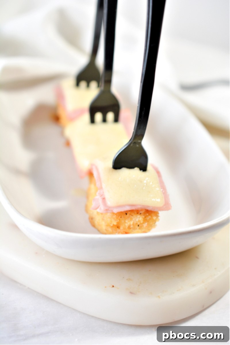 Keto Cordon Bleu Chicken Poppers 4 Several Keto Chicken Cordon Bleu Bites neatly arranged on a baking sheet.