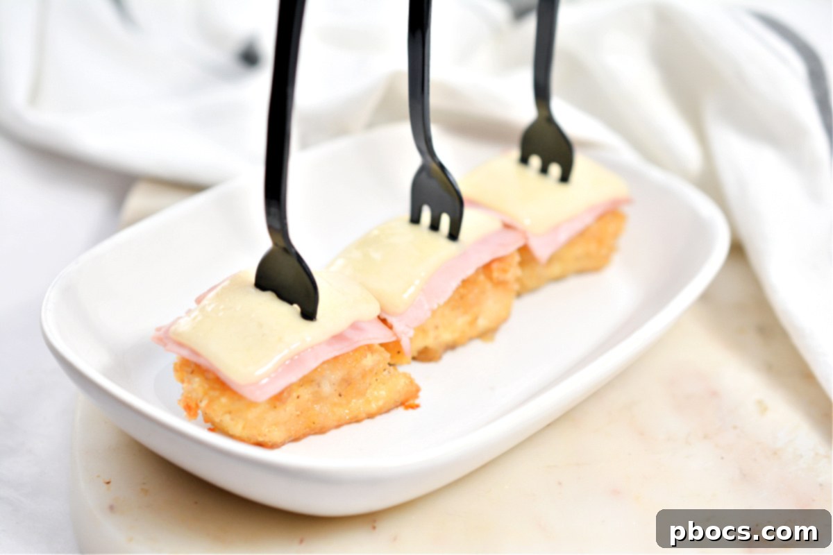 Keto Cordon Bleu Chicken Poppers 5 A stack of golden brown Keto Chicken Cordon Bleu Bites with a creamy sauce drizzle.