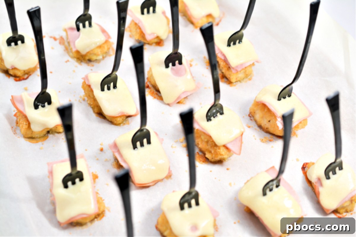 Keto Cordon Bleu Chicken Poppers 7 Several Keto Chicken Cordon Bleu Bites cooling on a wire rack after being baked.