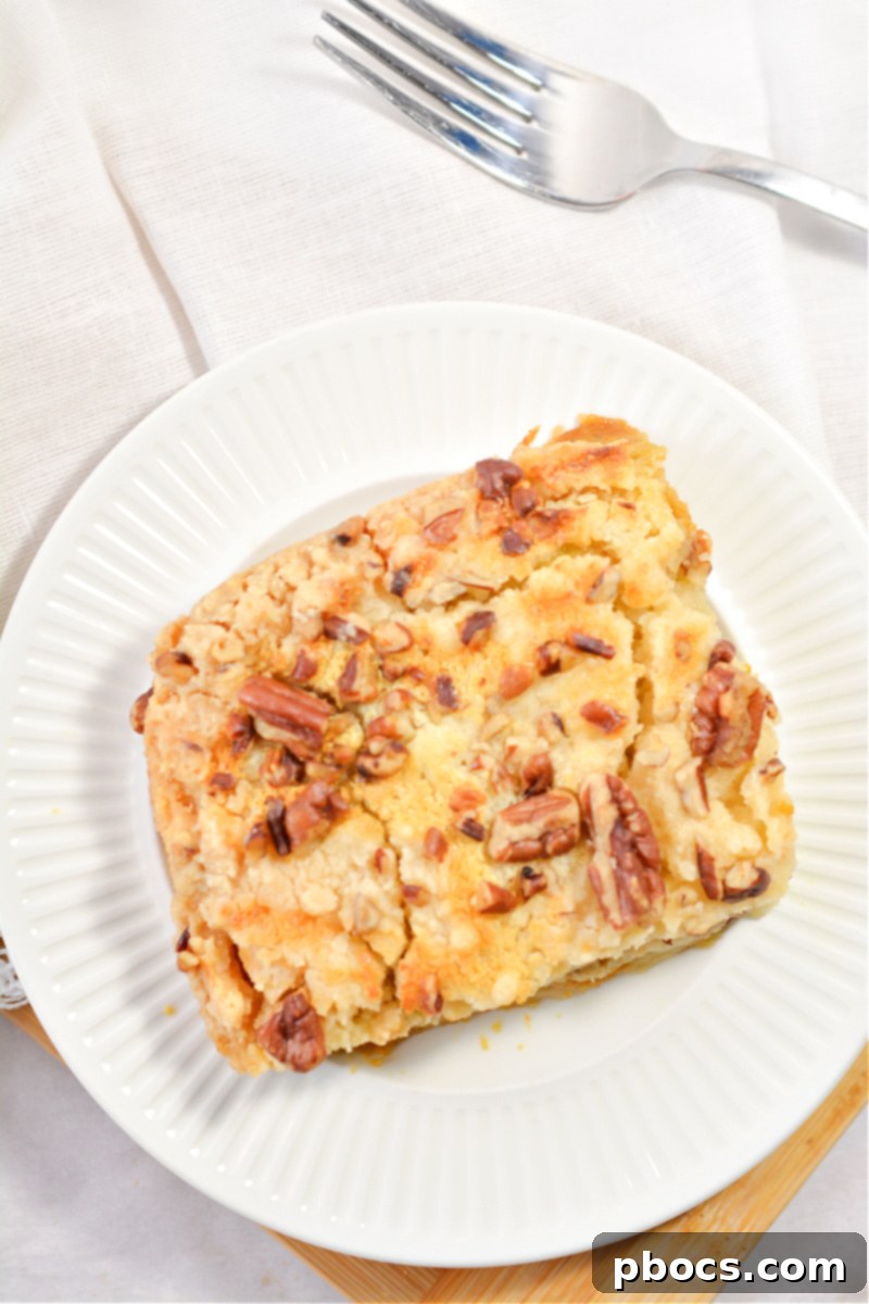 A vibrant close-up of the Keto Pumpkin Pecan Dump Cake with visible pecan pieces