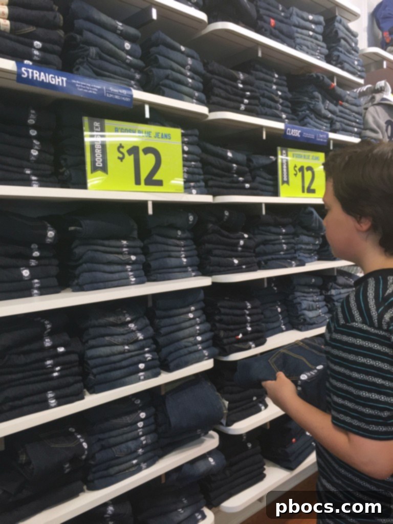 Stylish Back to School Outfits 25% Off OshKosh B'Gosh 4 A boy wearing a stylish back to school outfit featuring a sweater, green tee, khaki shorts, and a beanie