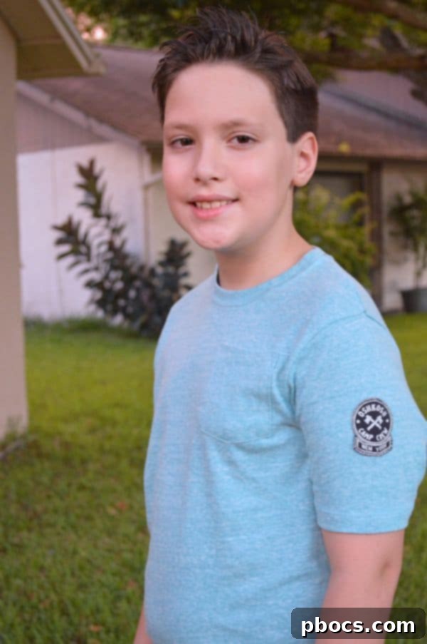 Stylish Back to School Outfits 25% Off OshKosh B'Gosh 9 A close-up of a boy smiling, showing off his stylish back to school outfit choices from OshKosh B'Gosh