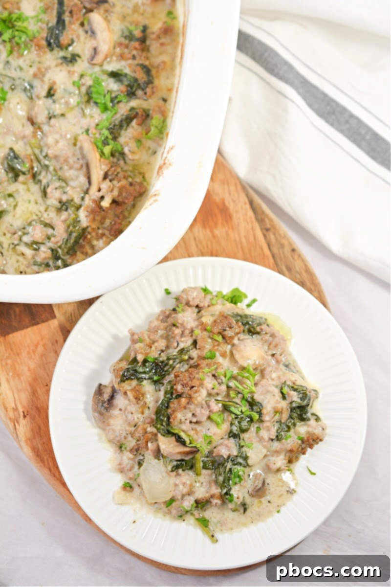 Ultimate Cheesy Keto Beef, Spinach & Mushroom Feast 3 Close-up of a bubbling Cheesy Keto Ground Beef Casserole with Spinach and Mushrooms, ready to serve.