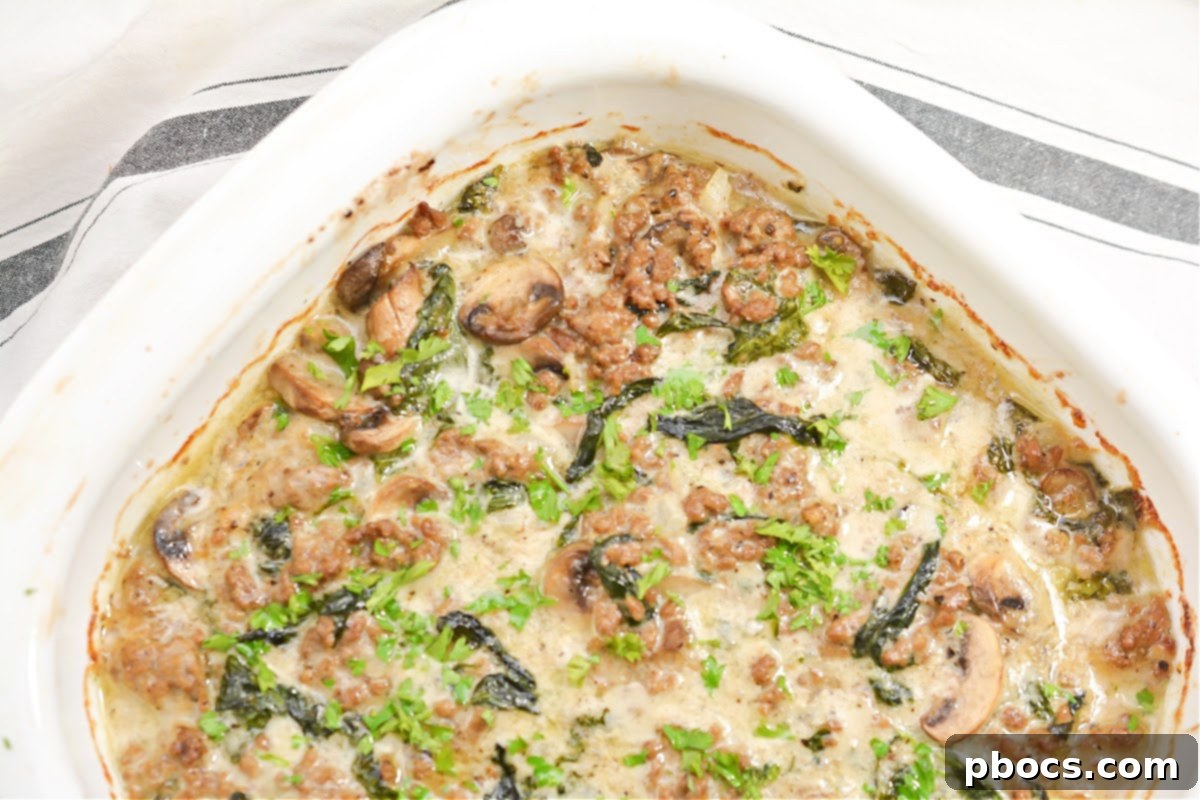 Ultimate Cheesy Keto Beef, Spinach & Mushroom Feast 4 Full pan of Cheesy Keto Ground Beef Casserole, showcasing its rich texture and cheesy top.