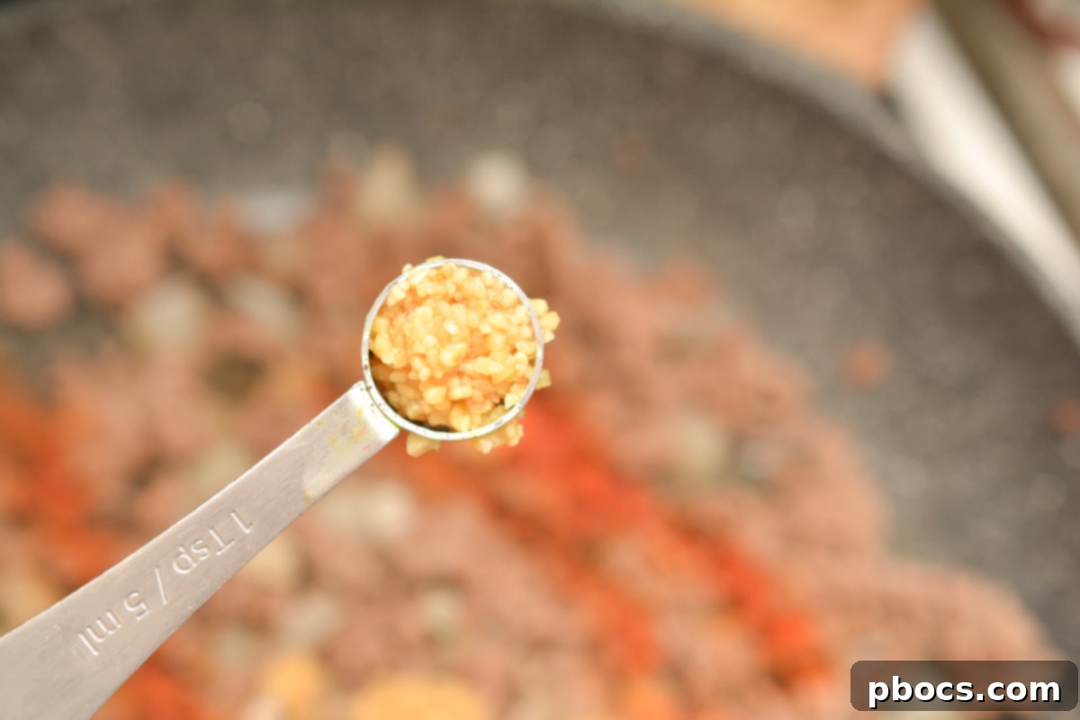 Keto Empanada Delights 12 Browning Ground Beef and Onions in a Skillet