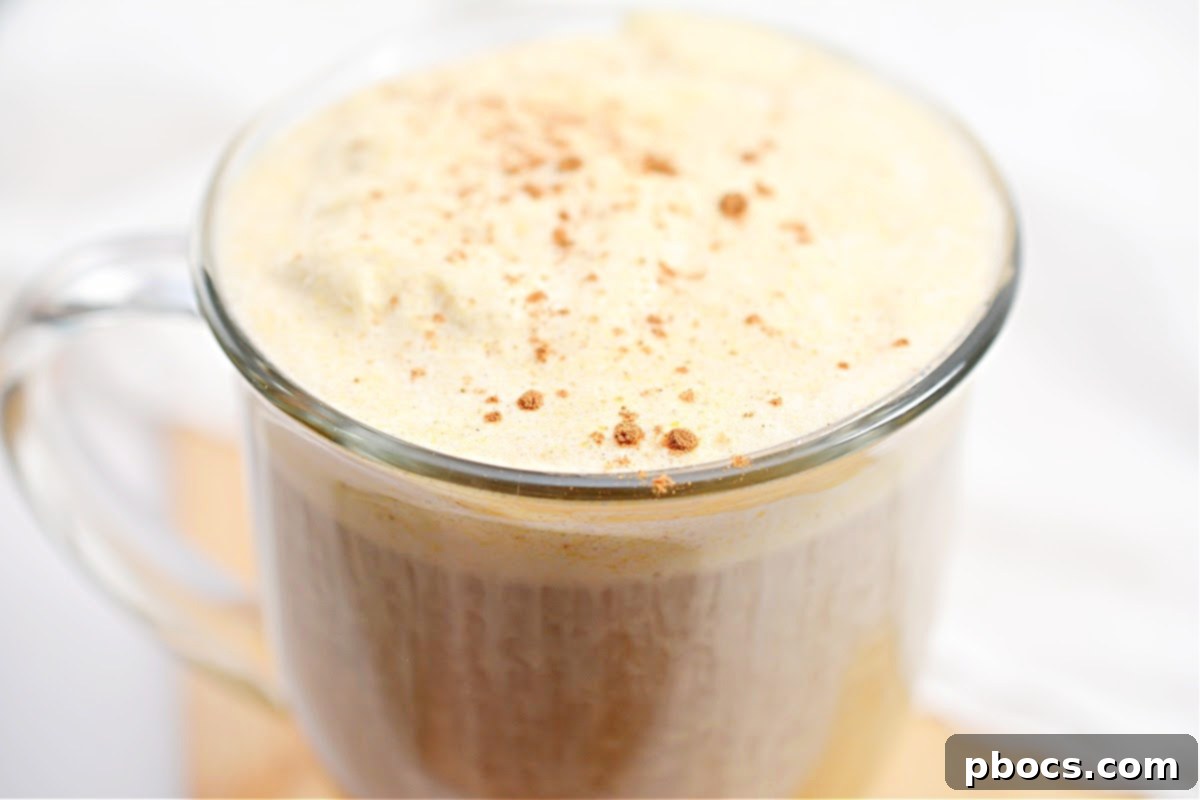 Close-up of a homemade Keto Pumpkin Cream Cold Brew with creamy foam and ice.