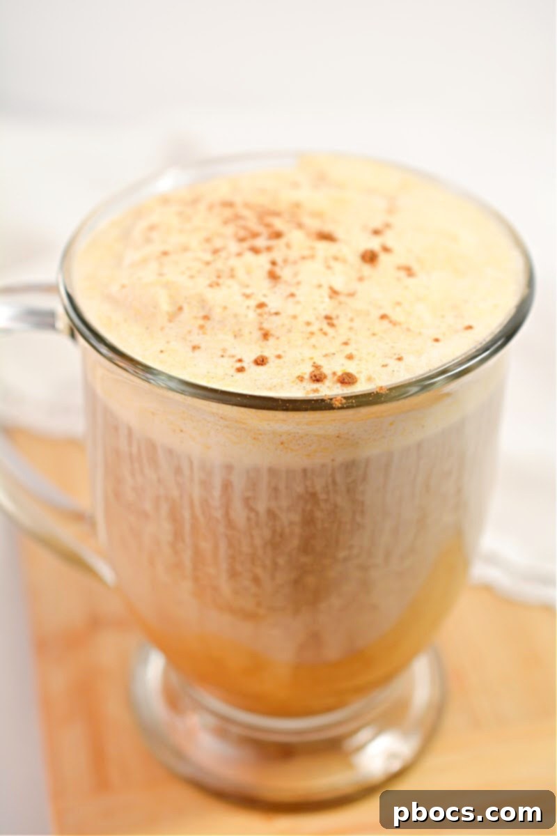 Overhead view of a glass of Keto Pumpkin Cream Cold Brew with a frothy top.