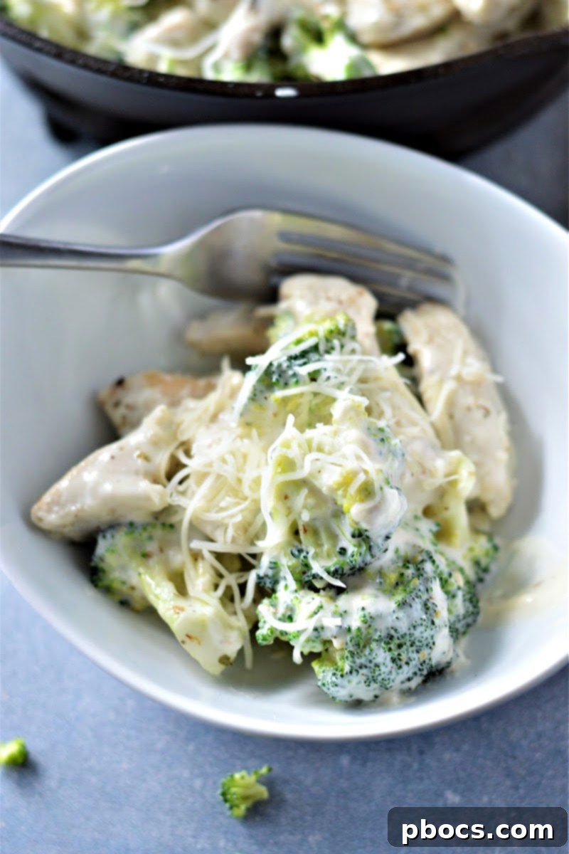 Creamy Low-Carb Chicken Alfredo 7 Cooked chicken strips being added to a creamy alfredo sauce.