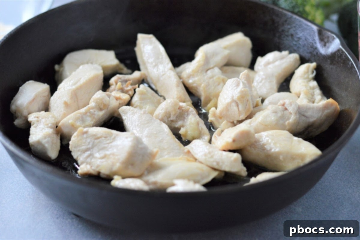 Creamy Low-Carb Chicken Alfredo 9 Chicken strips cooking in a skillet.