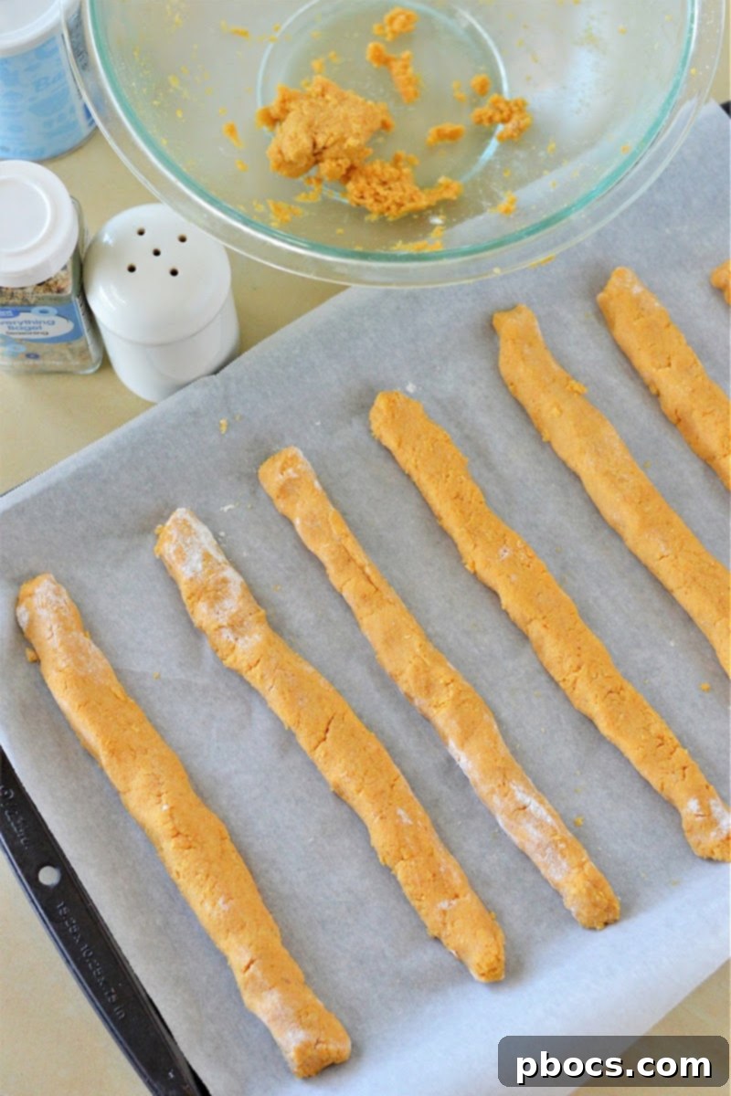 Placing breadsticks on a baking sheet and adding seasoning