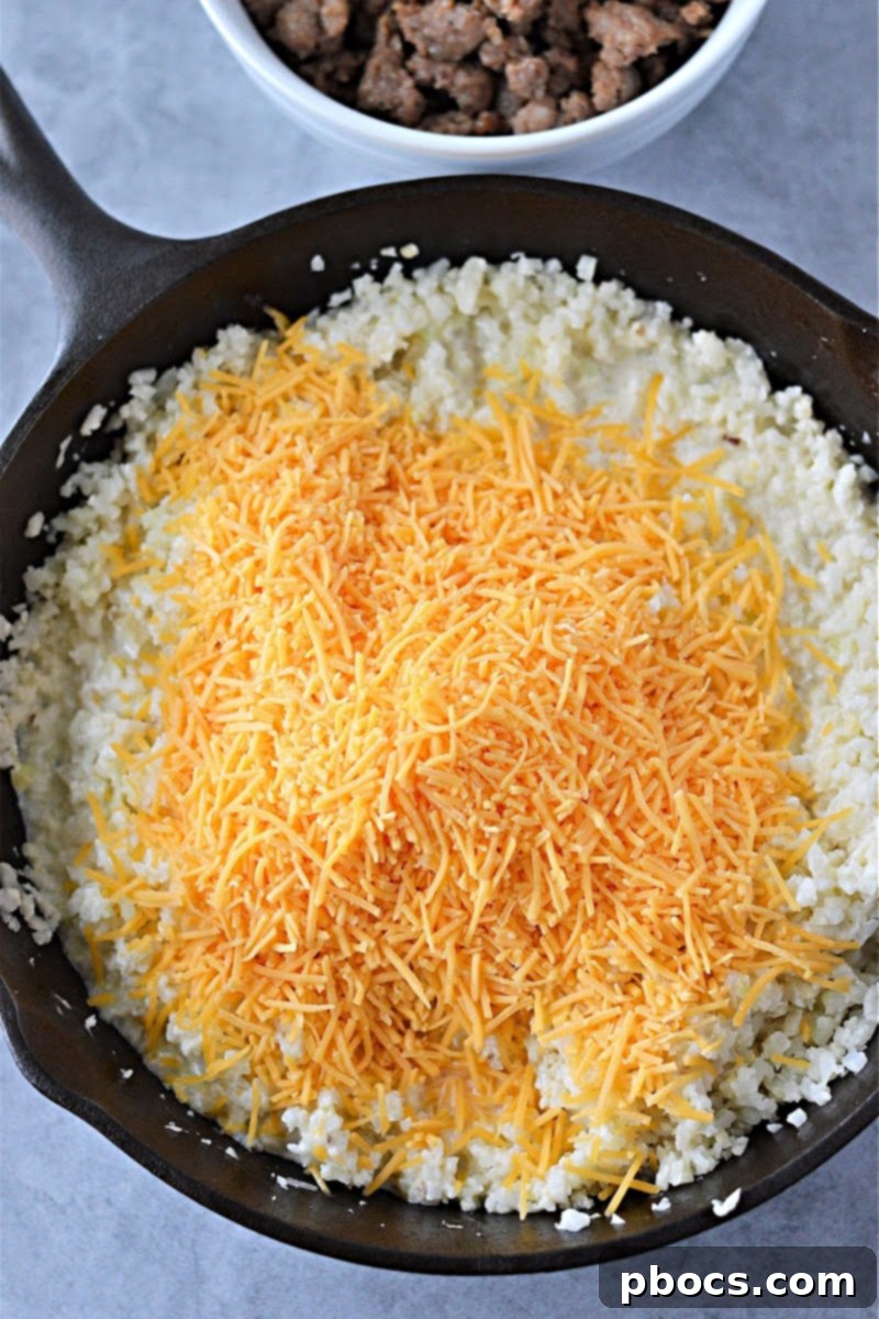 Adding Heavy Cream and Cheddar Cheese to Cauliflower Rice
