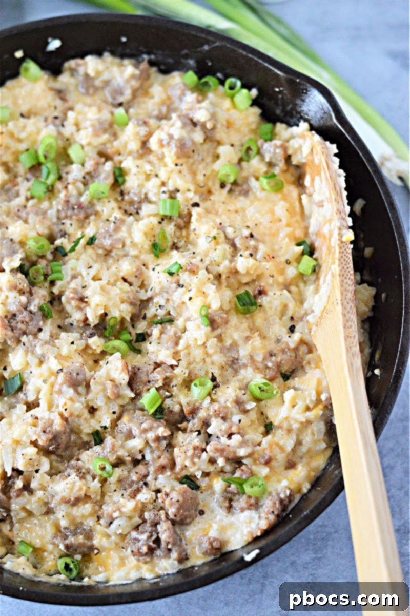 Serving of Keto Cheesy Cauliflower Rice with Sausage and Green Onions
