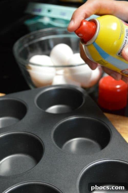 Muffin tin sprayed with butter for baking eggs
