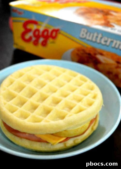 Assembling an Eggo breakfast sandwich with ham, egg, and cheese