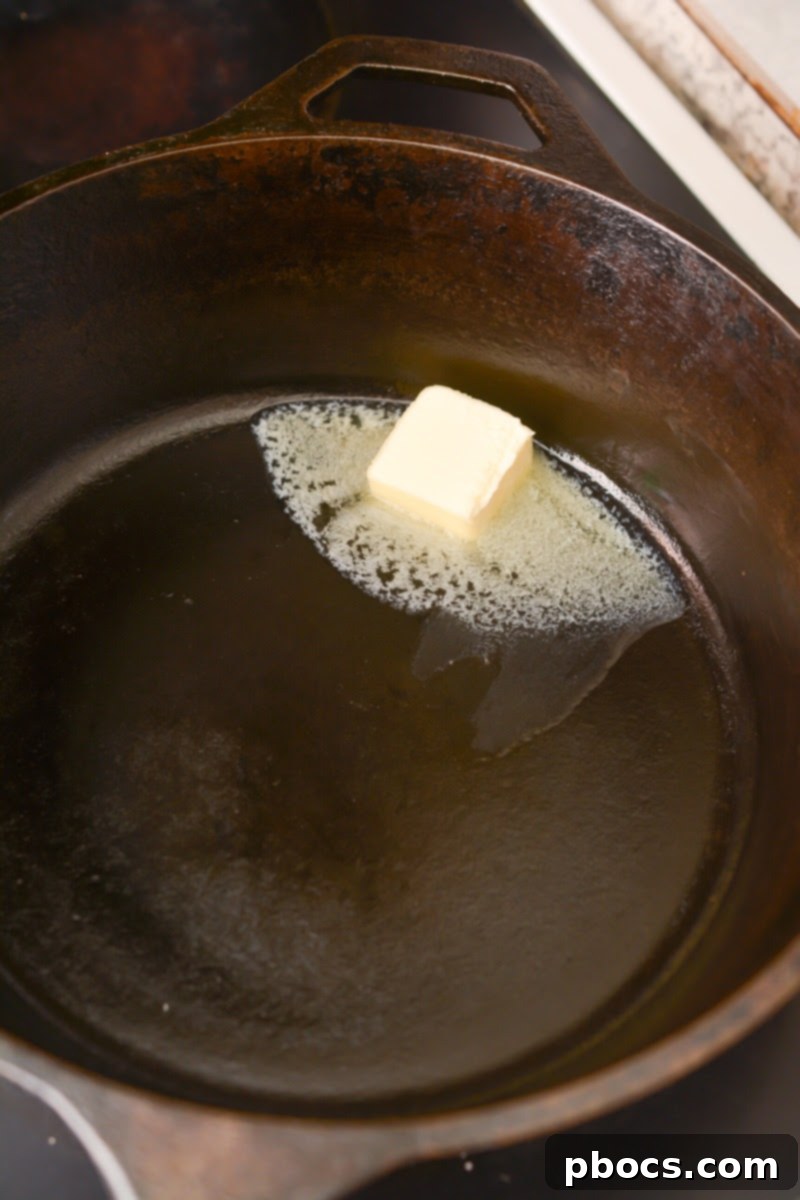 Butter melting in a cast iron skillet