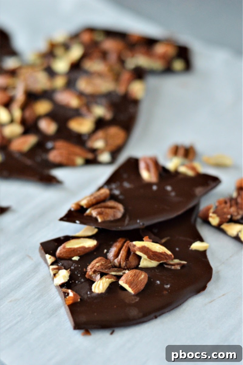 Sugar-Free Almond Pecan Keto Bark 7 Melted chocolate spread on parchment paper for Keto Chocolate Bark