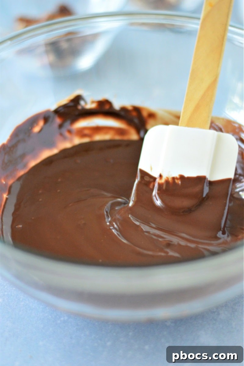 Sugar-Free Almond Pecan Keto Bark 8 Spreading melted chocolate on a baking sheet for Keto Chocolate Bark