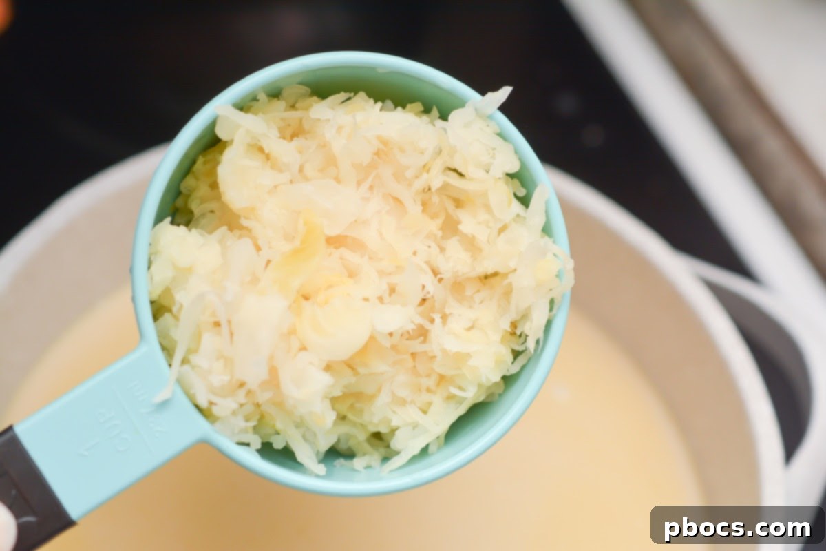 Hearty Keto Reuben Soup 11 Adding sauerkraut and corned beef to the simmering Keto Reuben Soup.