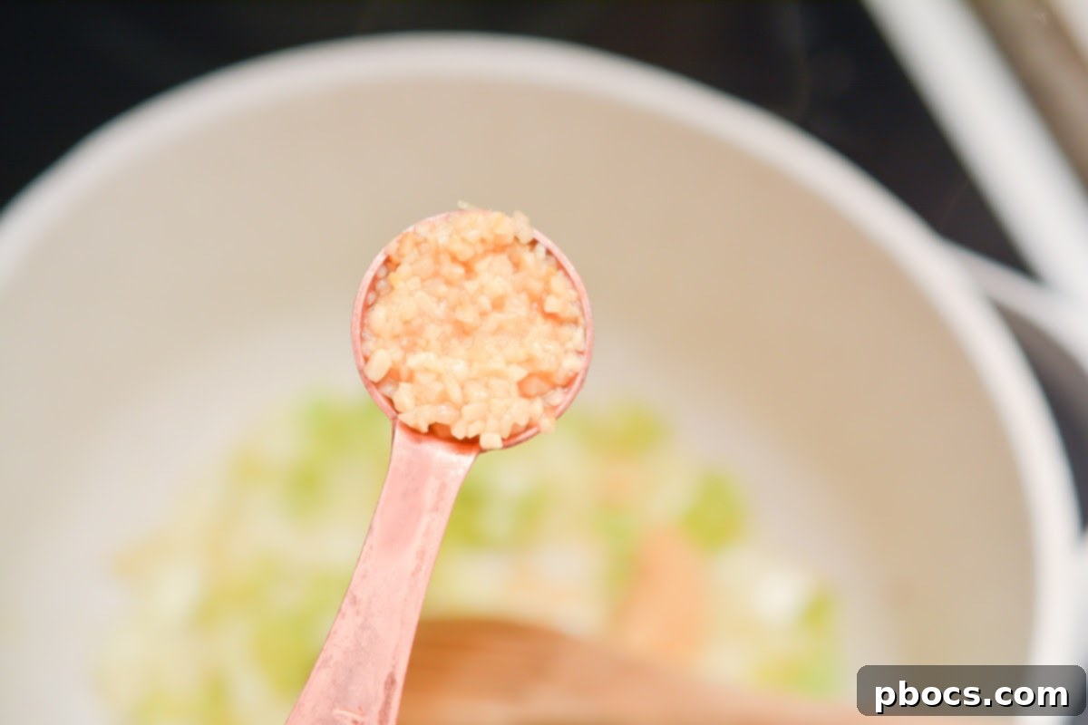 Hearty Keto Reuben Soup 9 Adding minced garlic to sautéed vegetables for the soup base.