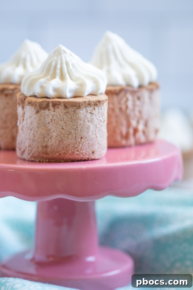 Keto Hot Chocolate Fat Bombs - A close-up of a single fat bomb on a plate, garnished with whipped cream and a sprinkle of cocoa powder.