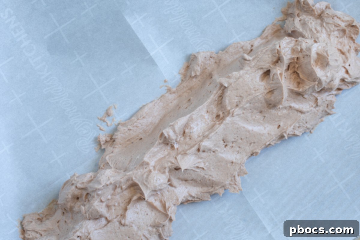 The fat bomb mixture rolled into a cylinder shape on parchment paper, ready for freezing.