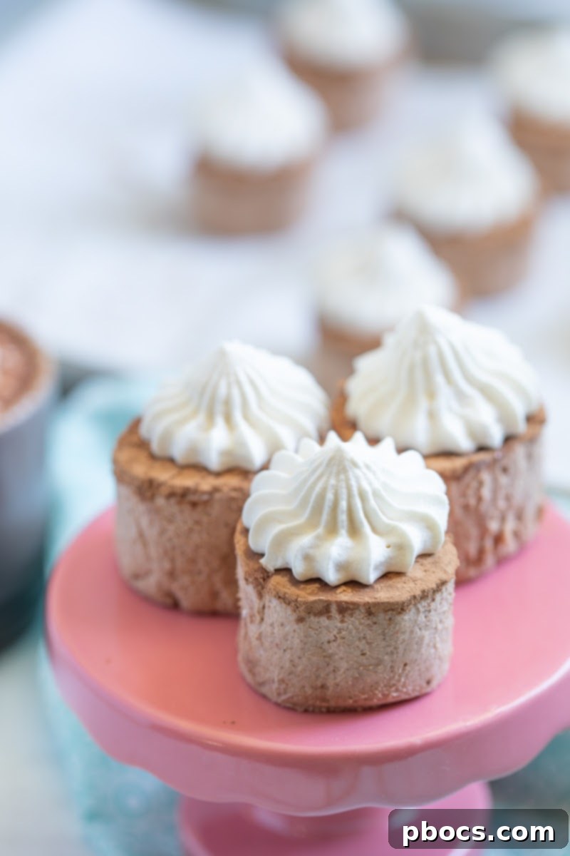 A beautifully presented Keto Hot Chocolate Fat Bomb with a generous swirl of white whipped cream on top, against a blurred background.