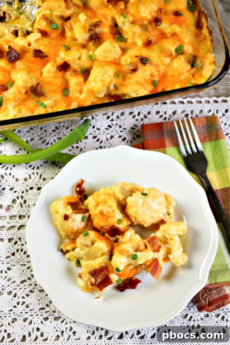 Rich and creamy Keto Cauliflower Au Gratin served in a white dish, ready to be enjoyed.