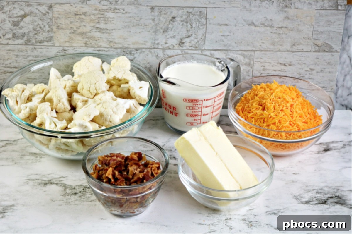 A dish of creamy Keto Cauliflower Au Gratin being prepared, showing the sauce poured over cauliflower.