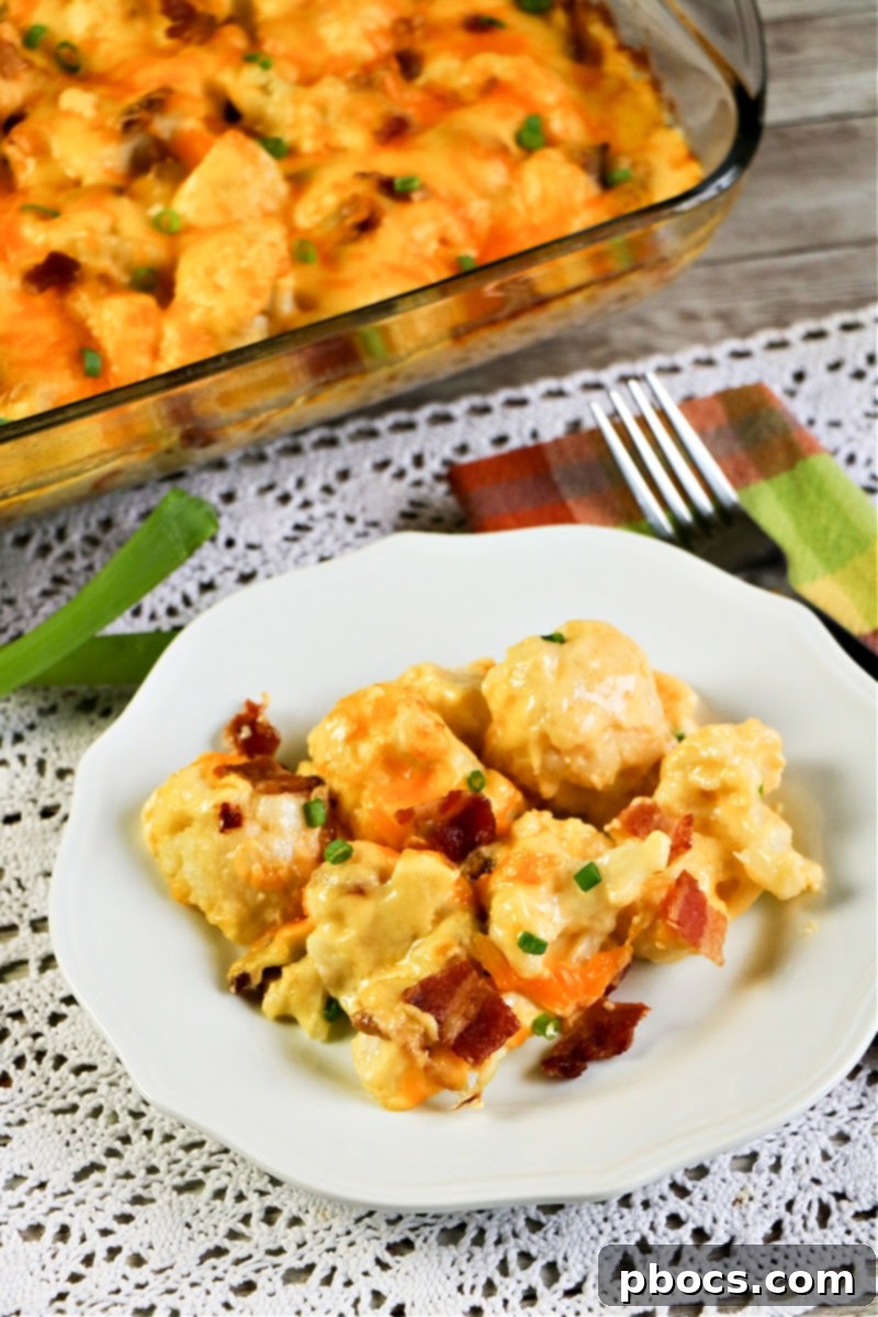 A close-up shot of uncooked Keto Cauliflower Au Gratin with broccoli florets mixed in, topped with cheese.