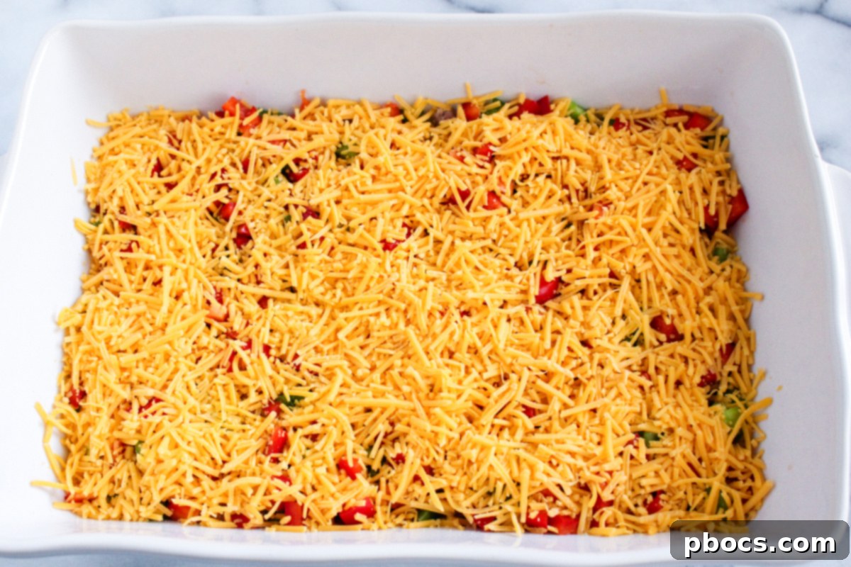 Savory Keto Breakfast Bake 8 Sausage, Bell Peppers, and Cheese in Baking Dish