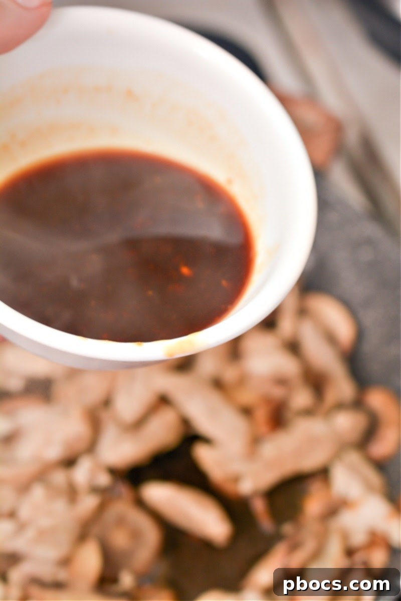 Keto Asian Mushroom Chicken Stir-fry 12 Keto Asian Chicken simmering in the sauce in a skillet