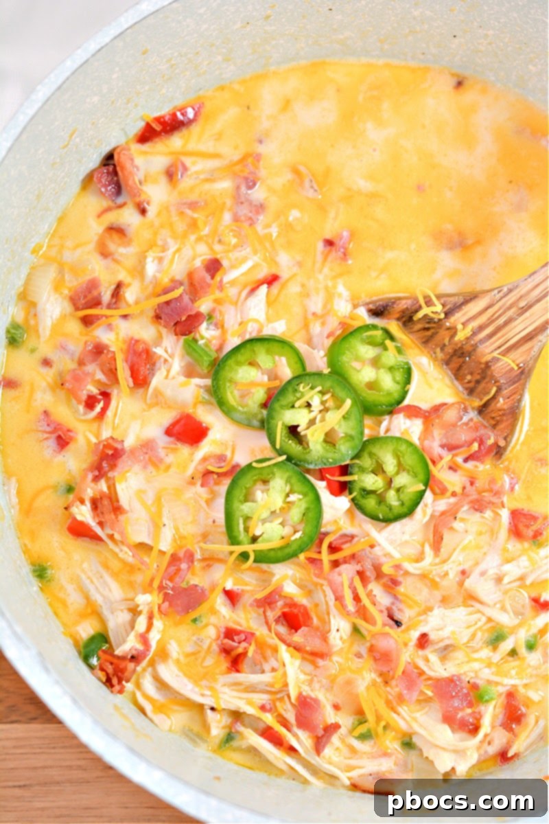 Creamy Keto Jalapeno Popper Soup 2 Creamy and spicy Keto Jalapeno Popper Soup in a bowl with fresh toppings
