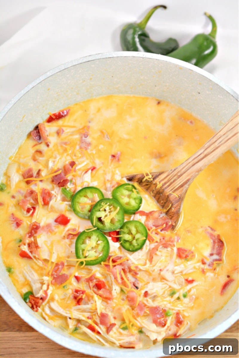 Creamy Keto Jalapeno Popper Soup 15 Finished bowl of Keto Jalapeno Popper Soup garnished with fresh jalapeno and bacon