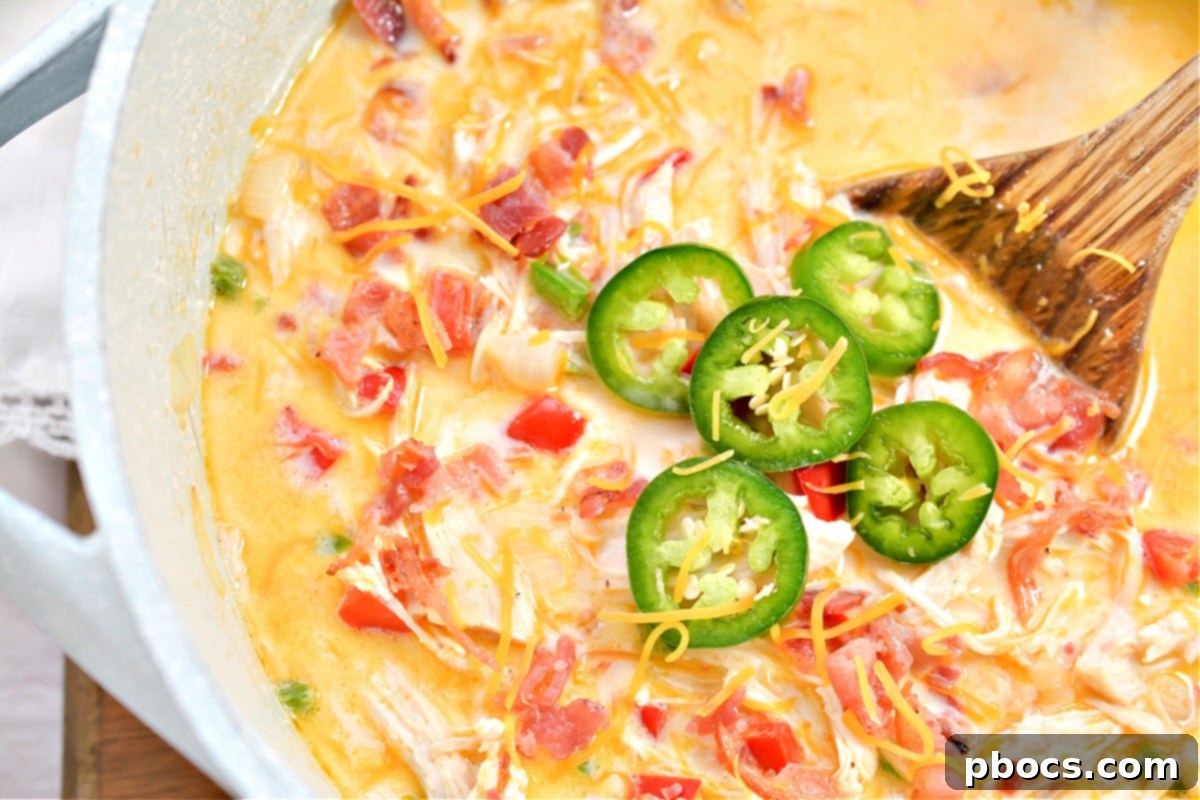 Creamy Keto Jalapeno Popper Soup 3 Close-up of a bowl of Keto Jalapeno Popper Soup with shredded chicken and cheese