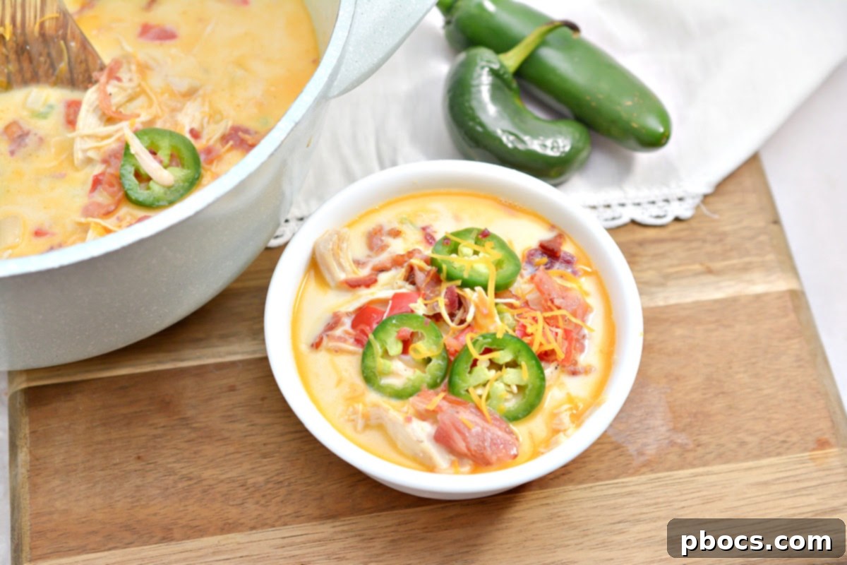 Creamy Keto Jalapeno Popper Soup 7 A large pot of Keto Jalapeno Popper Soup being stirred on the stove