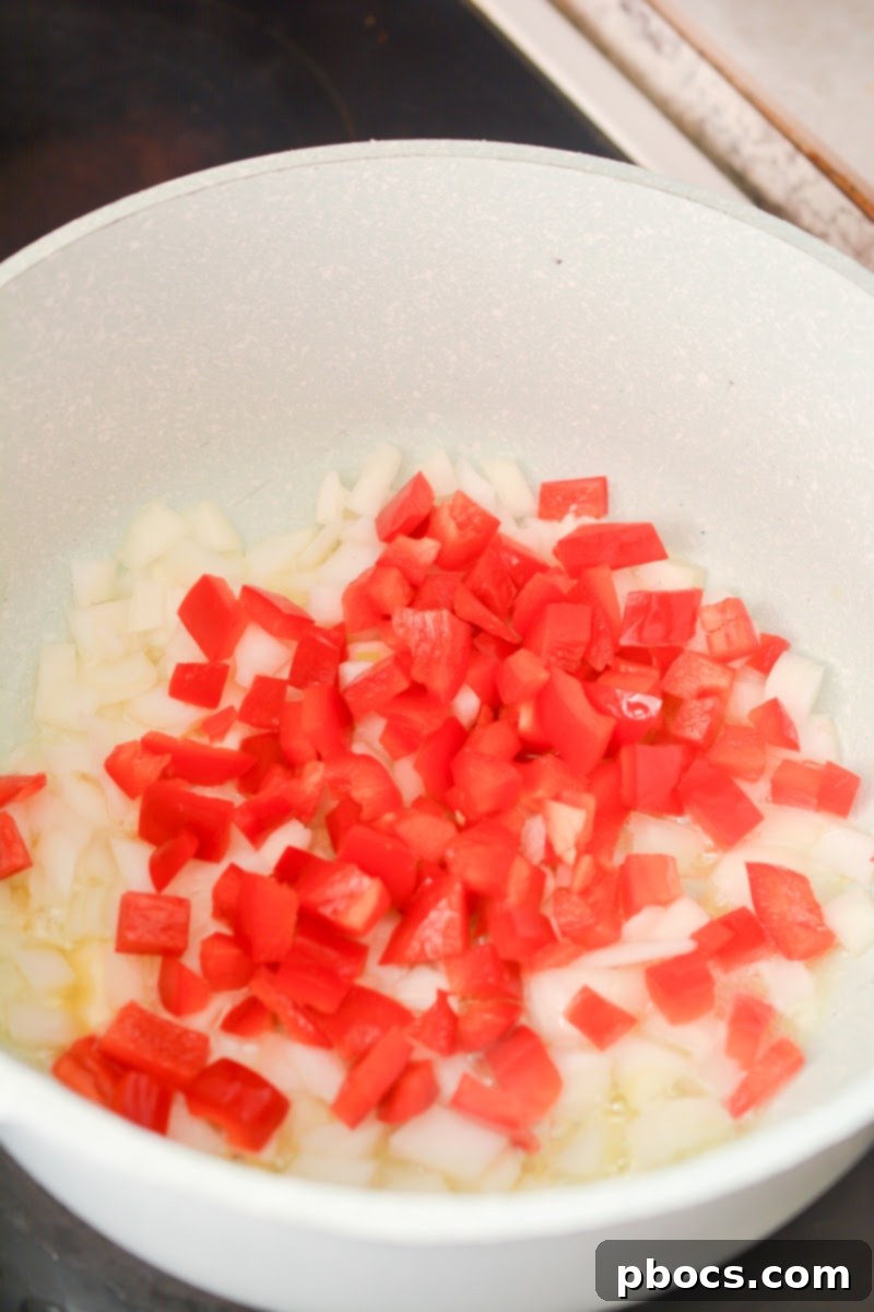 Creamy Keto Jalapeno Popper Soup 9 Onions and red bell peppers sautéing in butter