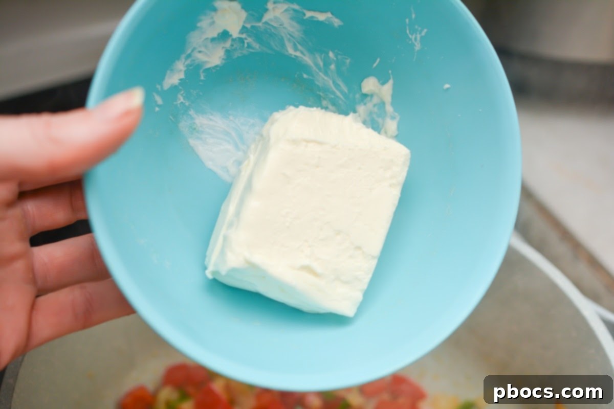 Creamy Keto Jalapeno Popper Soup 11 Cream cheese melting into the vegetable mixture