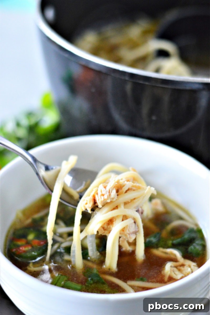Meal prep containers with low-carb chicken pho ready for storage, separate from fresh toppings.