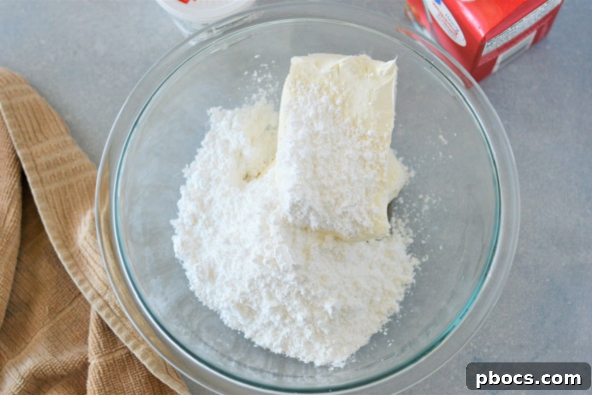 Mixing sour cream, vanilla, and heavy cream into the cheesecake base