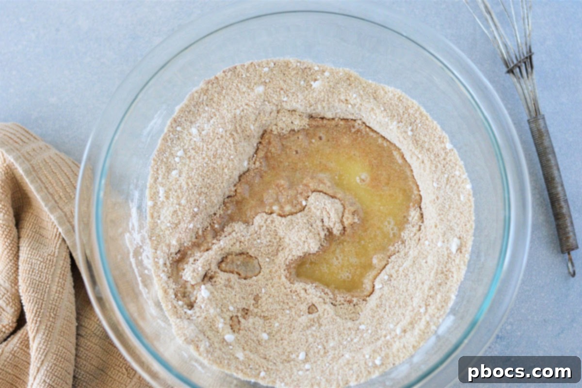 Adding melted butter to the crust mixture for Keto Churro Cheesecake Bars