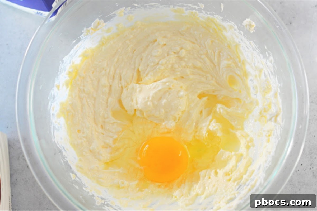 Beating cream cheese and sweetener for the keto Boston cream filling.