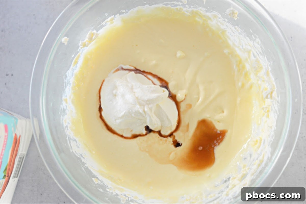 Mixing vanilla extract and sour cream into the keto filling.