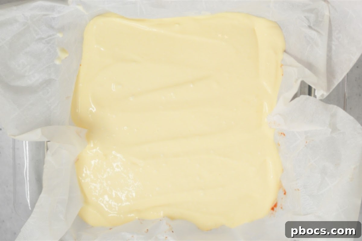 Pouring cream filling over the baked crust.