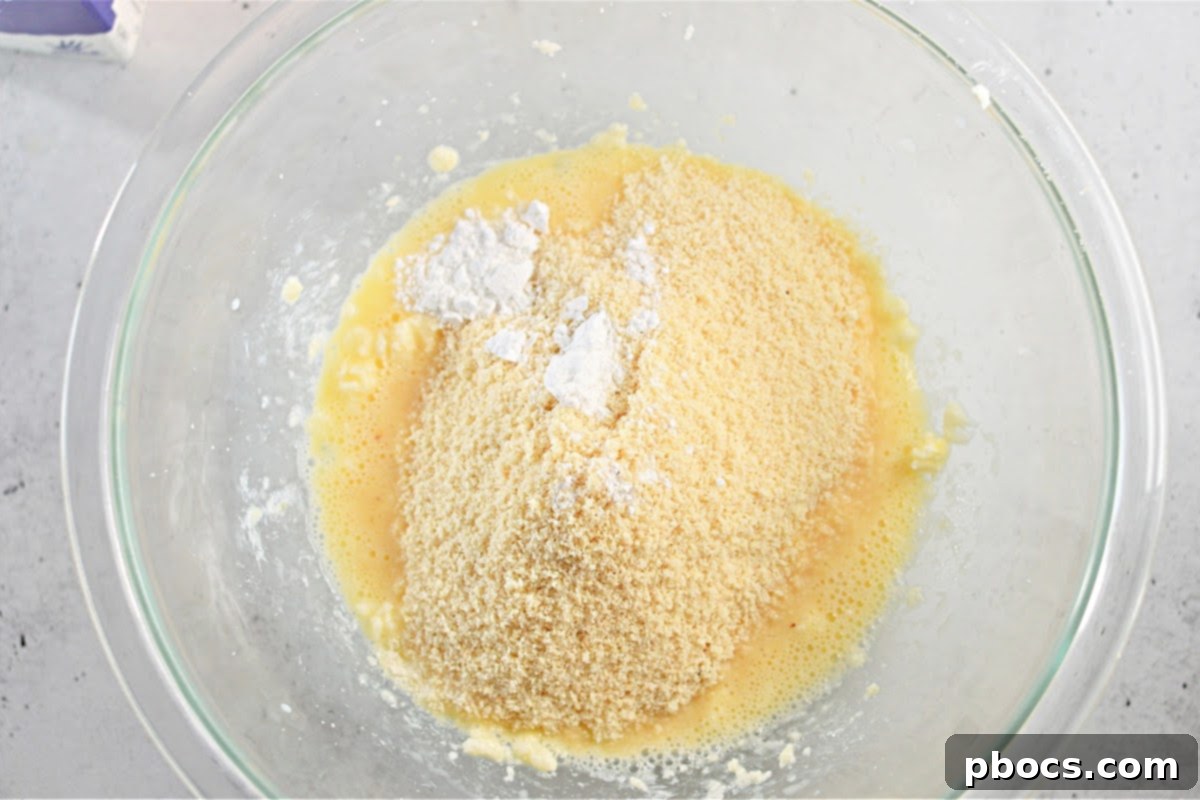 Adding egg, vanilla, and almond milk to the crust mixture.